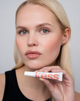warm-sands; ; Roos wears the Limited Edition SPF Lip Gloss in Warm Sands
