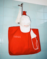 ; The large Limited Edition Sunset Shopper in Hot Orange paired with the Limited Edition Cap