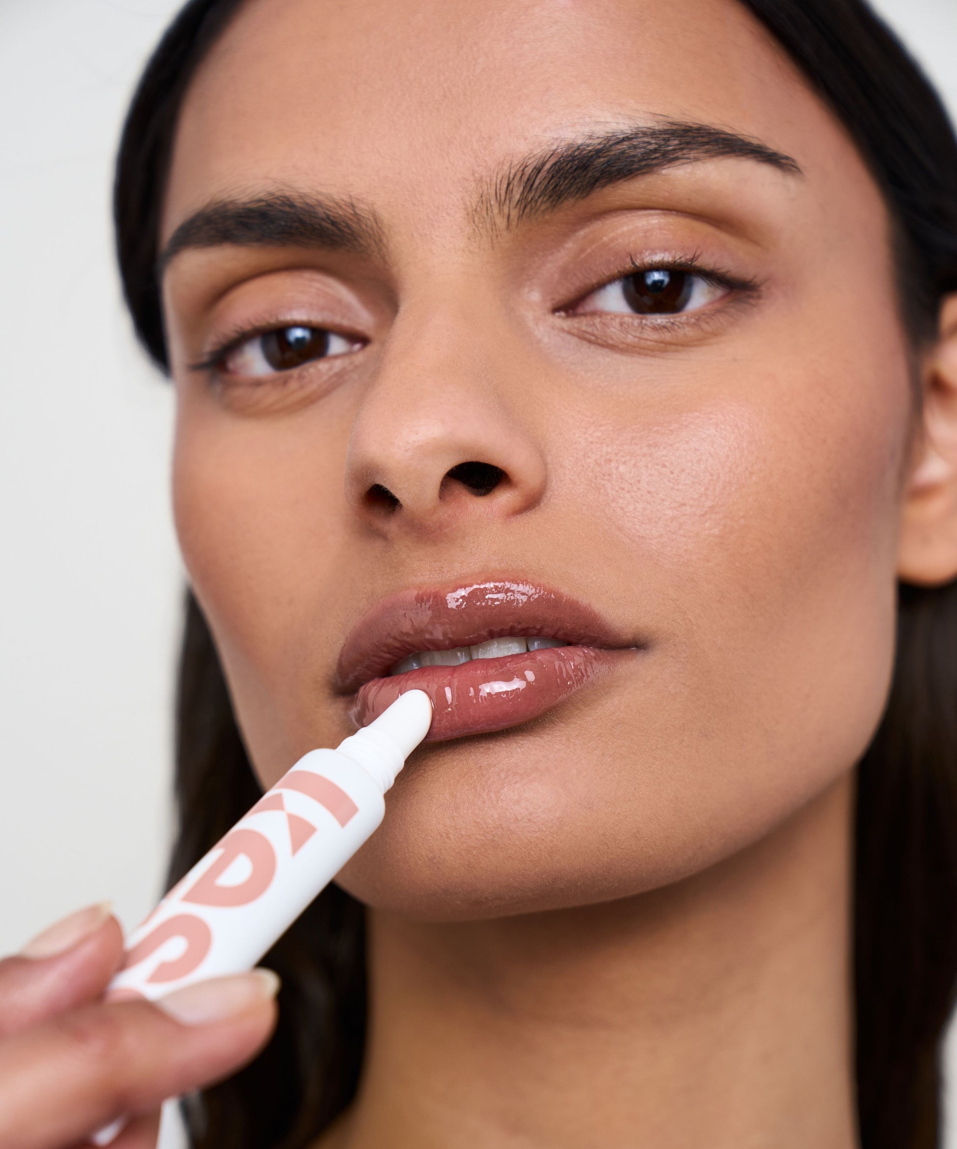lip-gloss-spf-15-off-duty-limited-edition; off-duty: Melanie wears the Limited Edition Lip Gloss in Off Duty
