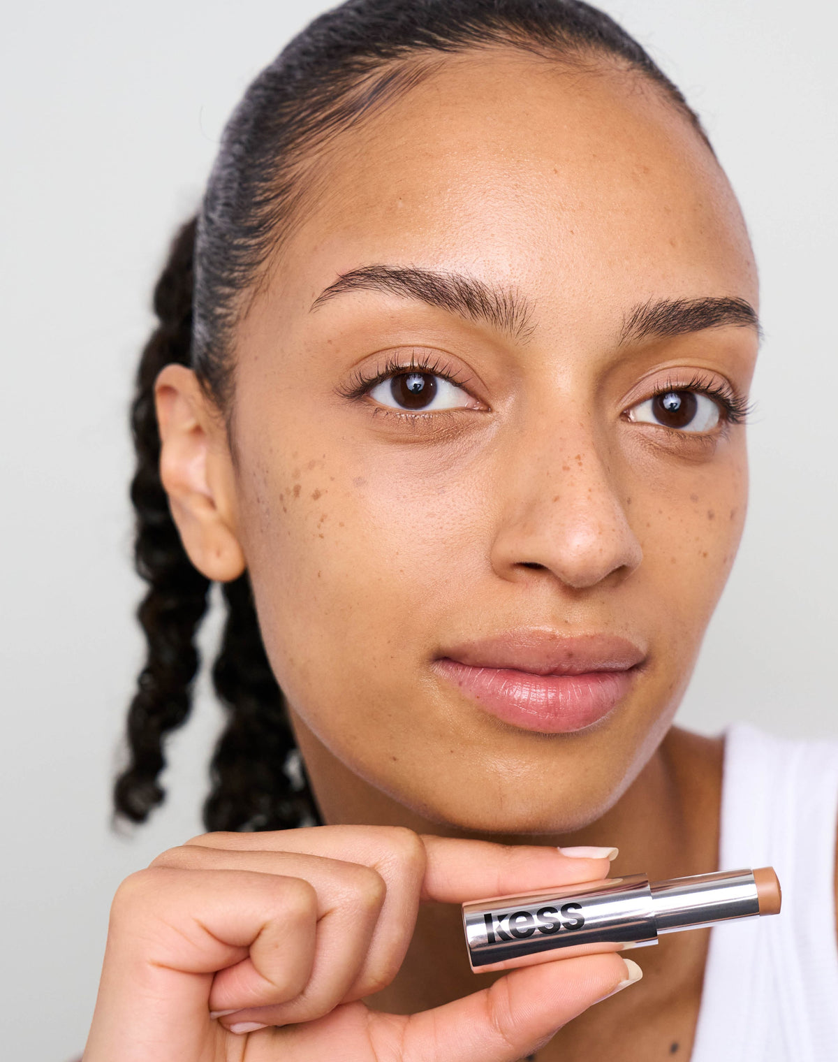 concealer-stick-spf-20; medium-to-tan: Trace wears the Concealer in Medium to Tan