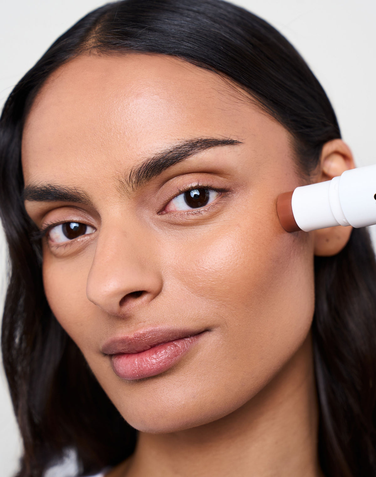 duo-stick; tan-bronzer: Melanie wears the Cream Bronzer in Tan