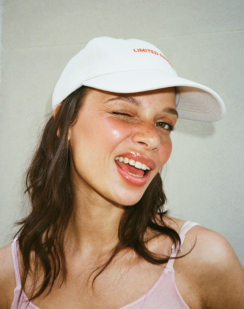; Stella wears the Limited Edition Cap