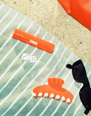 ; The Hot Orange Duo Stick and Duo Claw Clip in limited-edition
