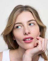 Kiss; Lydia wears the Triple Tint Lip Balm in Kiss