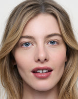 Naked; Lydia wears the Triple Tint Lip Balm in Naked