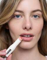 Nothin; Lydia wears the Triple Tint Lip Balm in Nothin'