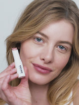 Naked; Lydia wears the Triple Tint Lip Balm in Naked